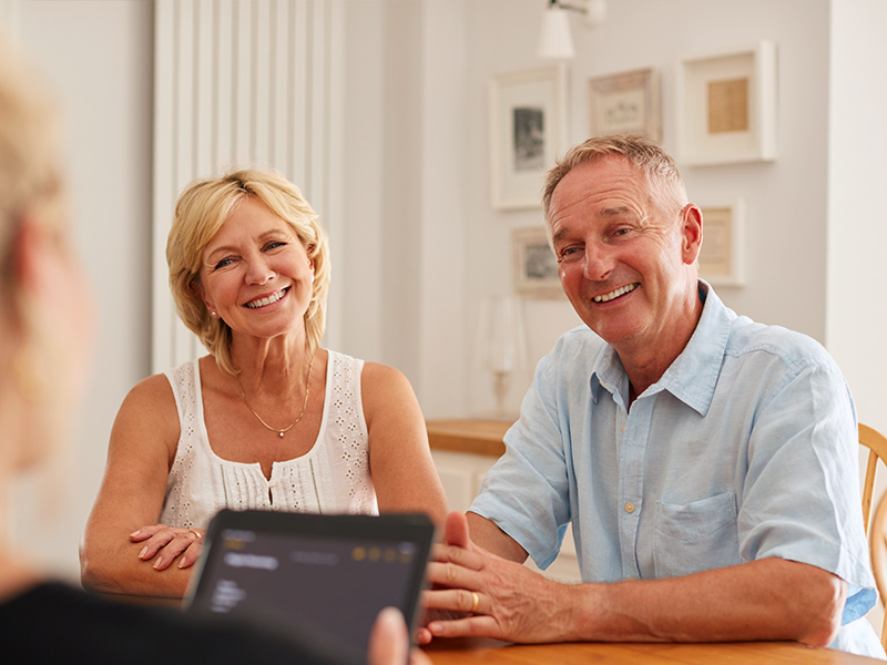 couple meeting with financial advisor to discuss safe retirement options