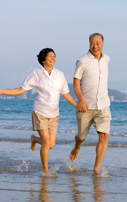 couple running on the beach together annuities