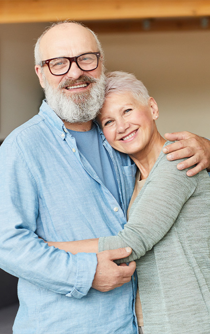 smiling couple embracing successful retirement strategies