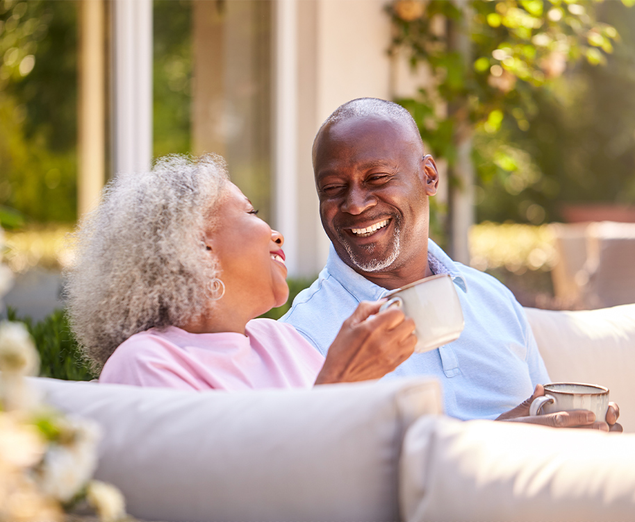 happy couple enjoying outdoors with mugs long-term care insurance jb retirement strategies florida